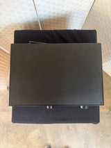 Black rectangular object on a textured surface