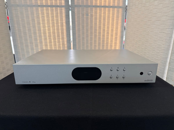 Silver audio equipment with 'audiobahn' branding on a black surface.