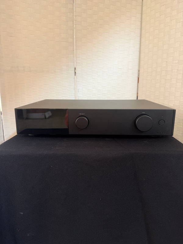 Black electronic device attached to a wall with a textured surface