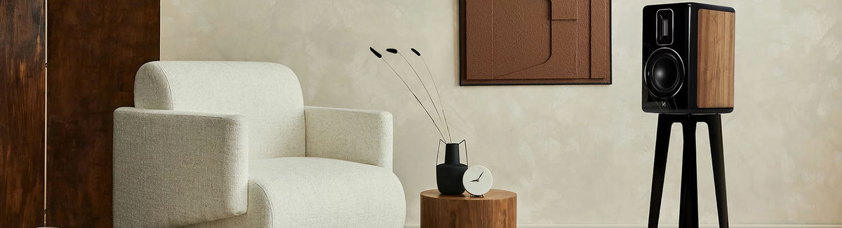 Quad Revela Series loudspeakers - the Revela 1 bookshelf and Revela 2 floorstanding models with a true ribbon tweeter, plus matching dedicated Revela 1 stands.